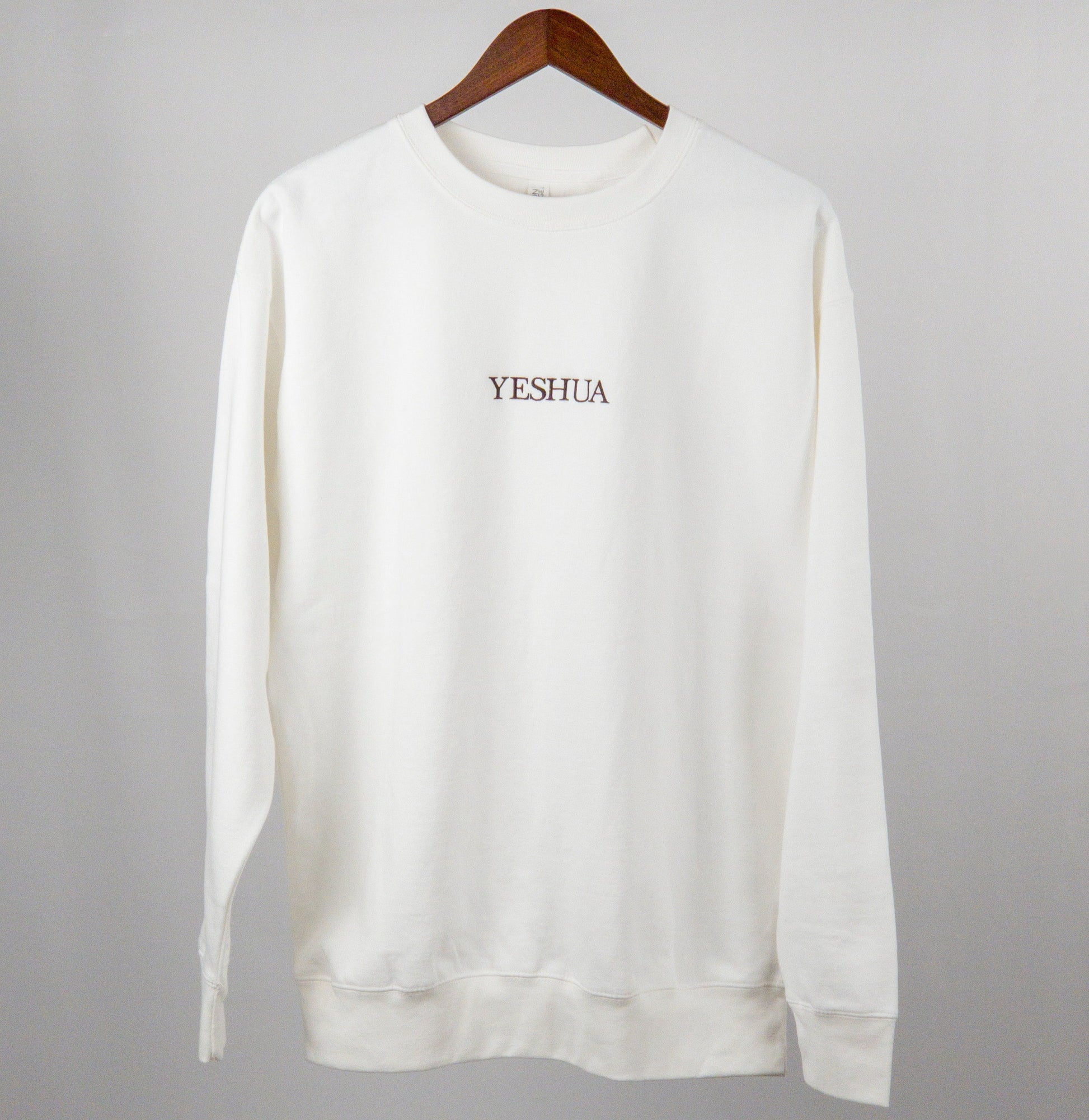 Discover the ultimate blend of comfort and style with our essential embroidered 'YESHUA' crew neck sweater. It’s more than just a piece of clothing; it’s a statement.